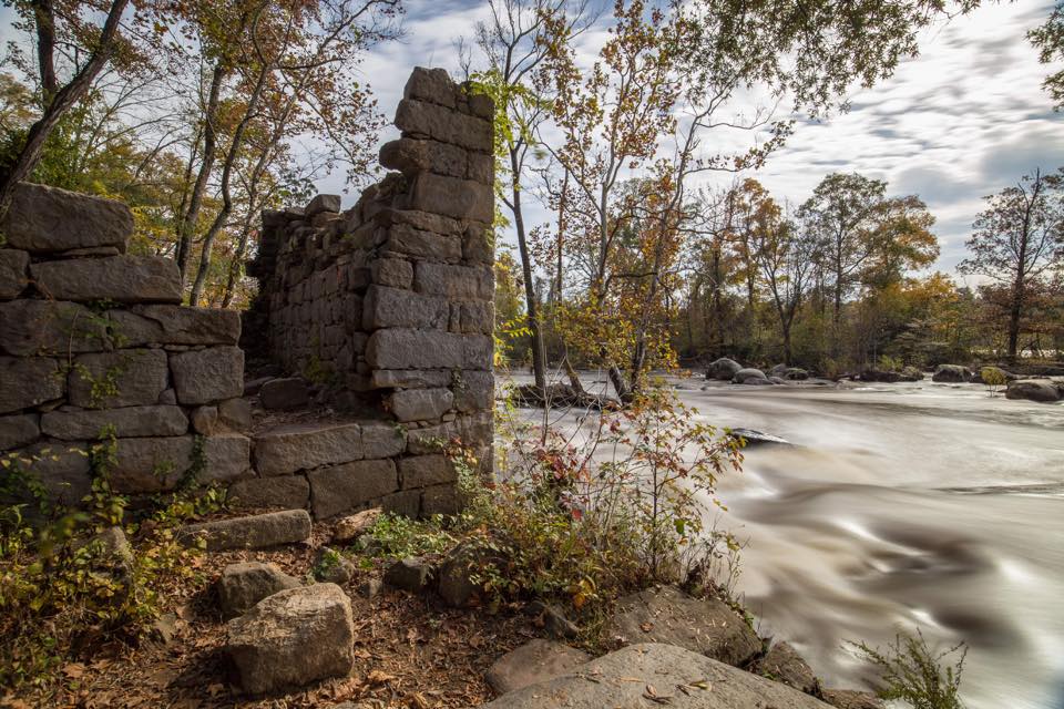 The stone ruins of Foushee Mill rising from the banks of the James River